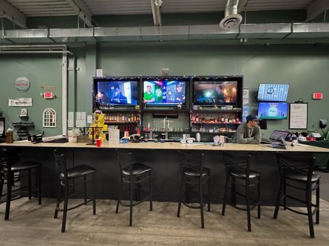 The Ashland bar: stools, taps and three TVs